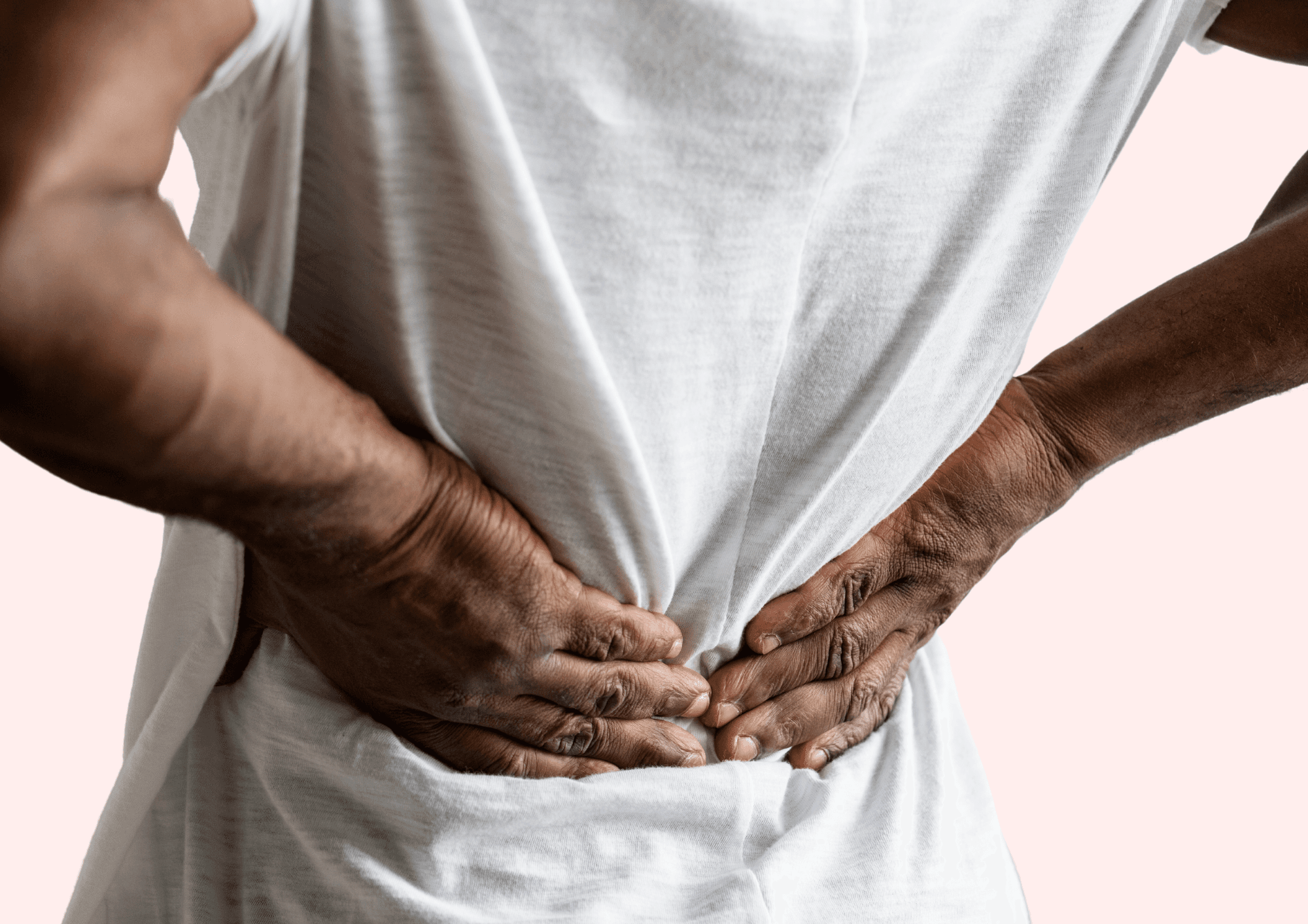 Man holds on to his lower back because he is in pain.